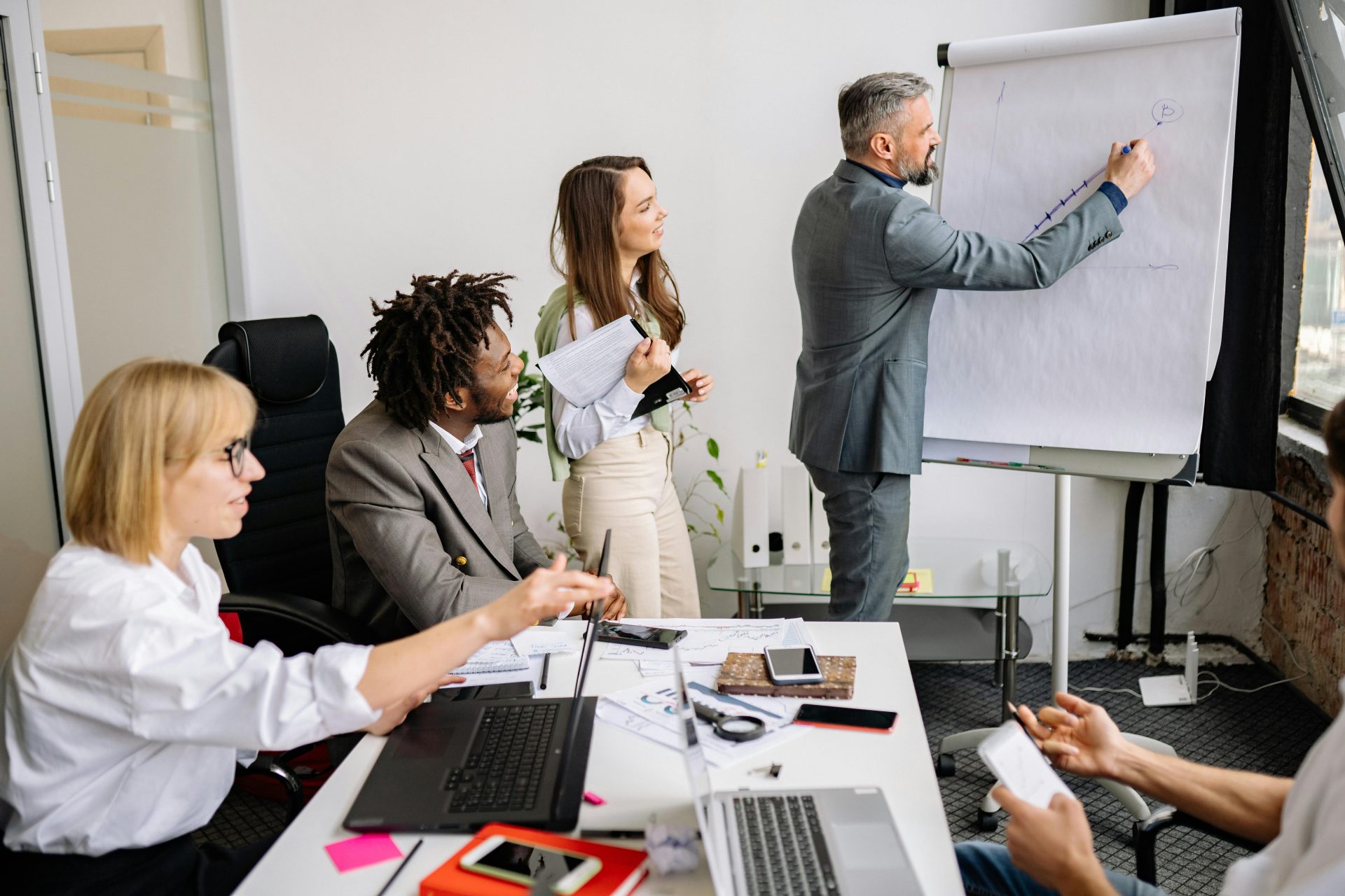 Geschäftsleute führen während einer Teambesprechung in einem modernen Konferenzraum ein Brainstorming durch und arbeiten zusammen.